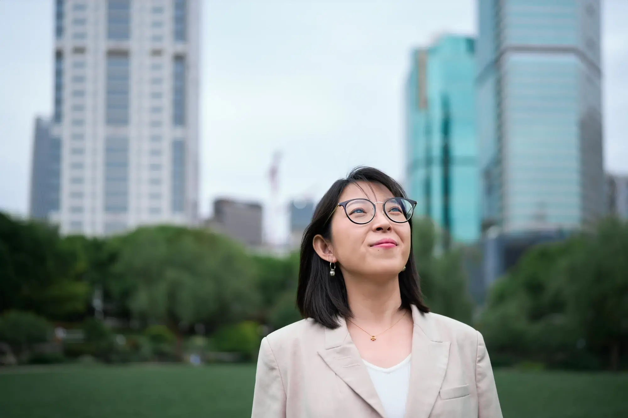 Portrait of a person standing outdoors in front of a city skyline